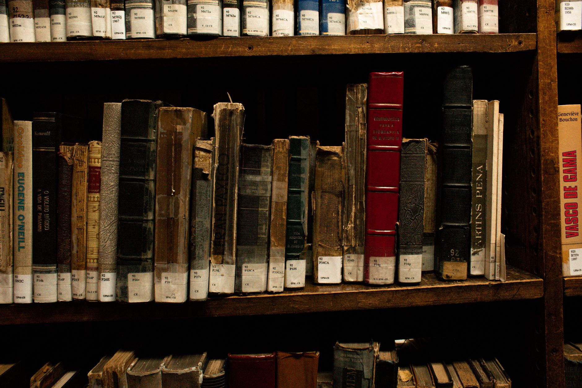Old and rare books on wooden shelves