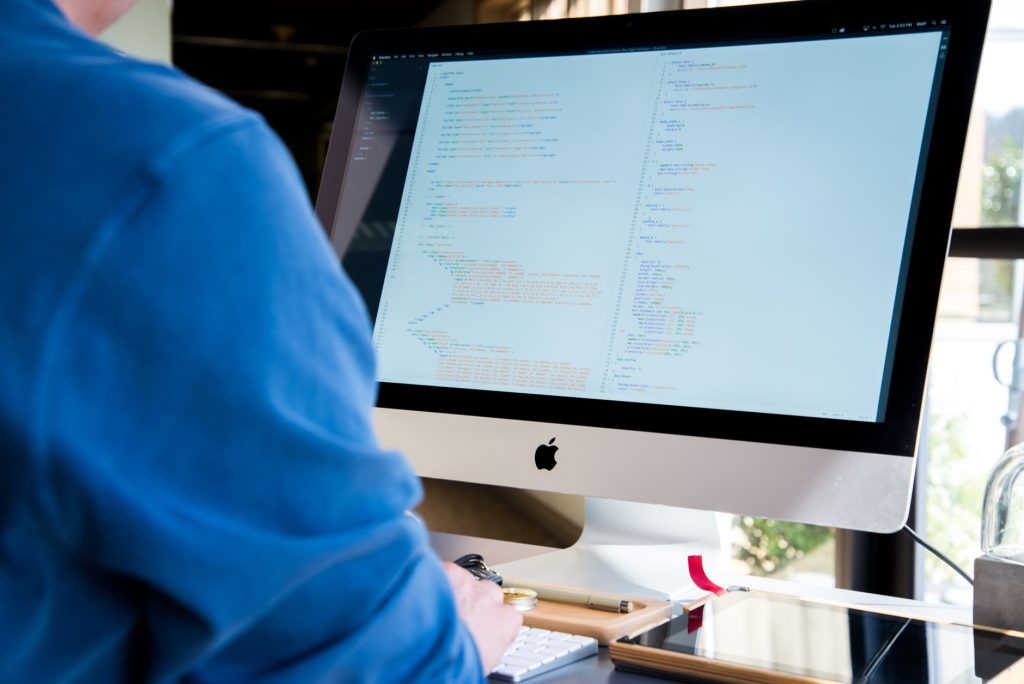 Programmer coding on an iMac